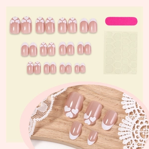 French tip press-on nail kit with white heart patterns and glitter gradient finish