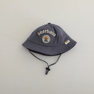 Detail of blue cotton baby bucket hat featuring bearbaby embroidery and bear patch