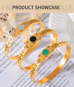 Detail of gold chain-link bracelet with green, black and white circular stone inlays