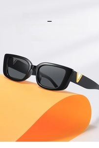 Detailed close-up of retro black rectangular sunglasses with golden V-logo metal decoration