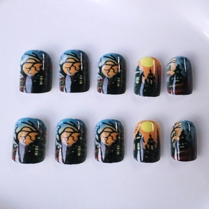 Short square Halloween press-on nails featuring dark castle and spooky forest landscape