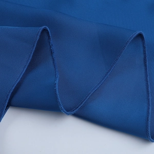 Detailed close-up of dark blue fabric texture with professional overlock stitching seams
