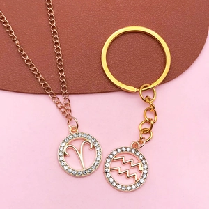 Zodiac rose gold necklace and gold keychain with Aries and Aquarius crystal charms