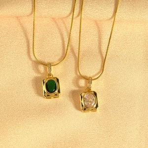 Luxurious gold necklaces with square emerald and white zircon pendants on silk