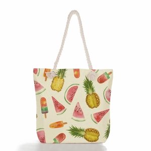 Detail of canvas beach tote featuring colorful fruit prints and soft cotton rope handles
