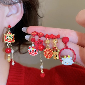 Detail of Chinese New Year lion dance earrings with red enamel and lucky character charms