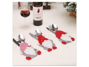 Three Christmas gnome cutlery holders set against a festive dining scene with wine accessories