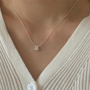 Close-up of 925 sterling silver bunny pendant necklace with rhinestones on model