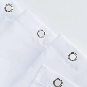 Close-up of durable white fabric shower curtain with reinforced silver metal grommets