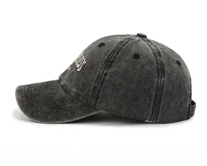 Side view of washed charcoal cotton baseball cap with white freedom embroidery detail