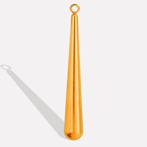Macro shot of 18k gold plated teardrop pendant with smooth polished finish for DIY jewelry