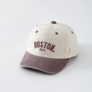 Detail of embroidered BOSTON 1630 text on vintage cotton baseball cap with purple visor