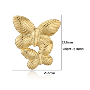 Macro detail of gold butterfly earrings showing dimensions of 27.7mm by 23.5mm