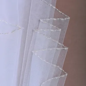 Elegant white bridal tulle veil with handmade silver beaded wave edge and crystals