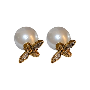 Elegant gold bee stud earrings with white pearl backings and sparkling rhinestones
