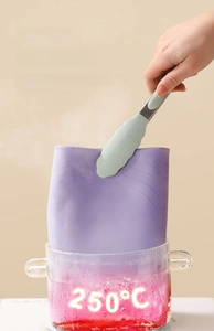 Close-up of purple silicone mat being boiled in glass pot at 250°C for heat test