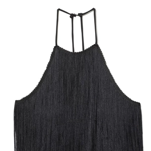 Detail of elegant black velvet halter neck dress with long silky fringe tassels