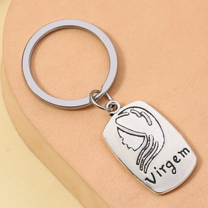Detailed macro view of retro silver Virgo zodiac keychain with engraved female icon
