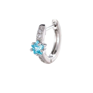 Silver star-shaped zircon huggie hoop earring with light blue crystal and white background