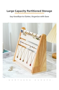 Detailed close-up of a three-tier wooden jewelry display stand with beige velvet lining
