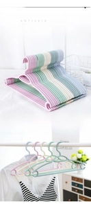 Detail of non-slip plastic hanger with windproof hook and curved seamless shoulder design