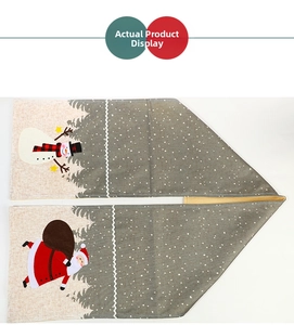 Detail of Christmas table runner with Santa Claus and snowman embroidery on cotton linen fabric