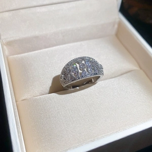 Macro view of silver bow-knot ring with micro-paved cubic zirconia and hollow design
