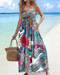 Detail of vibrant paisley floral print on a long summer beach backless maxi dress