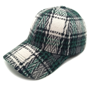 Close-up of the vintage plaid pattern and thick textured wool fabric on a baseball cap