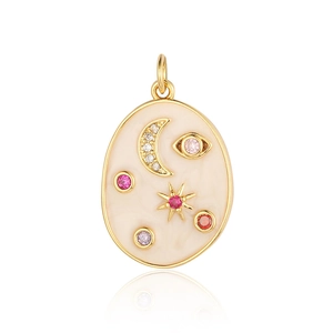 Detail of oval gold pendant with beige enamel, celestial moon and star gem patterns