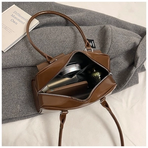 Internal view of the brown pillow bag showing spacious capacity and smooth PU texture