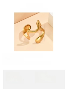 Detail view of gold irregular wavy stainless steel ring with 2cm interface width