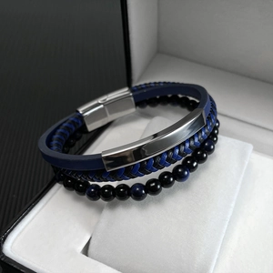 Detail of multilayer woven leather bracelet with black glass beads and magnetic clasp