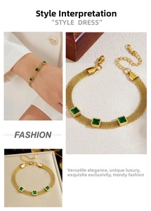 Detail of gold mesh chain bracelet with three square emerald green zircons and lobster clasp