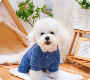 Detail of warm navy blue fleece pet jumpsuit with brand patch in a cozy indoor setting