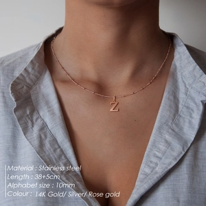 Elegant stainless steel beaded necklace featuring a rose gold letter Z pendant on a model