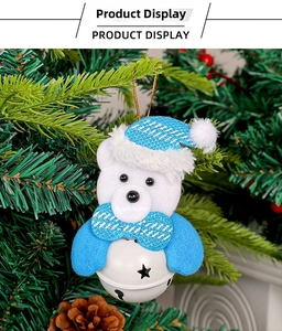Detailed view of white plush bear ornament with blue glitter hat and metal star bell