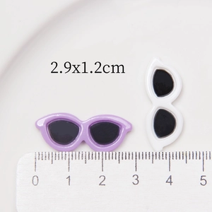 Detailed view of 2.9cm resin miniature sunglasses for DIY with measurement ruler