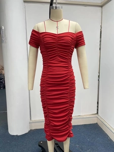 Detail of red off-shoulder pleated dress showing fine smocked texture and slim fit design
