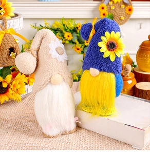 Detail of plush gnome dolls with sunflower decor and white beard on a rustic background