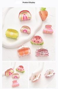 Macro detail of acrylic hair clips featuring colorful fruit and rainbow patterns