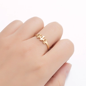 Close-up of gold stainless steel adjustable ring with cutout 444 angel numbers