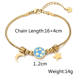 Detailed macro view of gold-plated celestial bracelet with star moon pendants and blue enamel