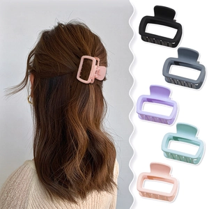 Matte square hair claw clips in five colors shown with a model wearing a high ponytail