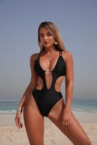 Detail of black cutout swimsuit with deep V-neck and decorative golden metal buckle