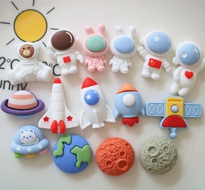 Dettaglio di ciondoli astronauta e razzo in resina per decorazioni fai-da-te cover