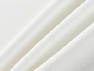 Close-up of premium white ribbed knit fabric showing fine texture and soft material detail