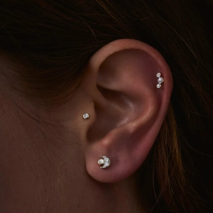 Detail of silver S925 moon stud and diamond earring set on ear with zircon accents
