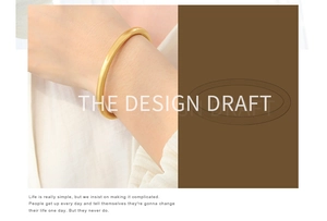 Detailed close-up of a matte gold minimalist bangle worn on a wrist for a sleek style