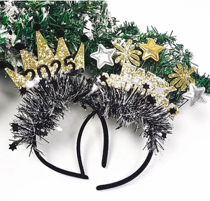 Detail of 2025 New Year headbands with gold crowns and glitter stars for party decor